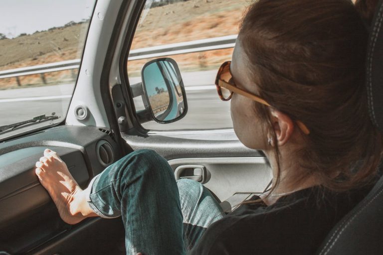 Woman With Foot Up Inside A Vehicle