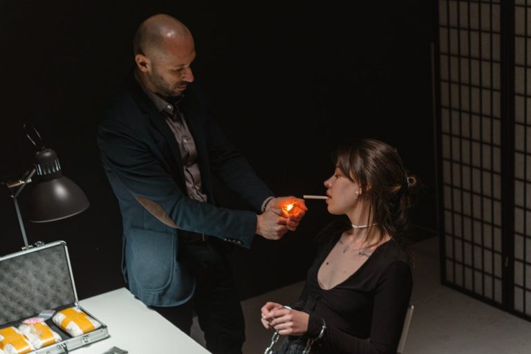A Man Lighting Up a Woman's Cigarette