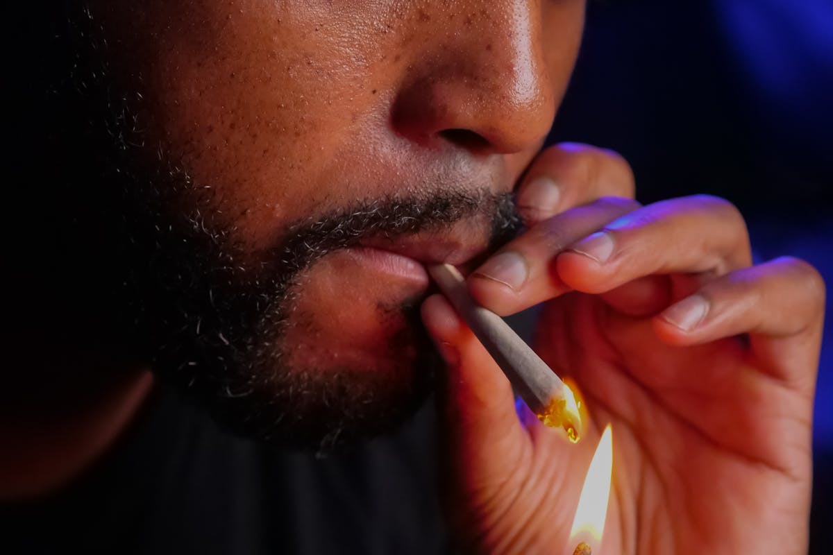 Close-Up Photo of Man Lighting Up the Blunt