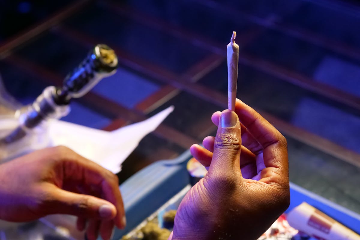 Close-Up Photo of Person Holding Blunt