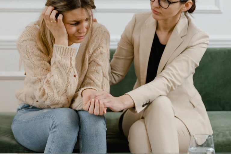 Person Wearing Beige Blazer Comforting the Crying Woman