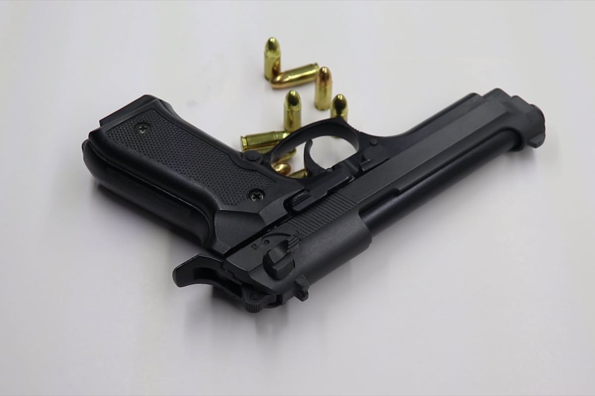 Pistol and Bullets on a White Background