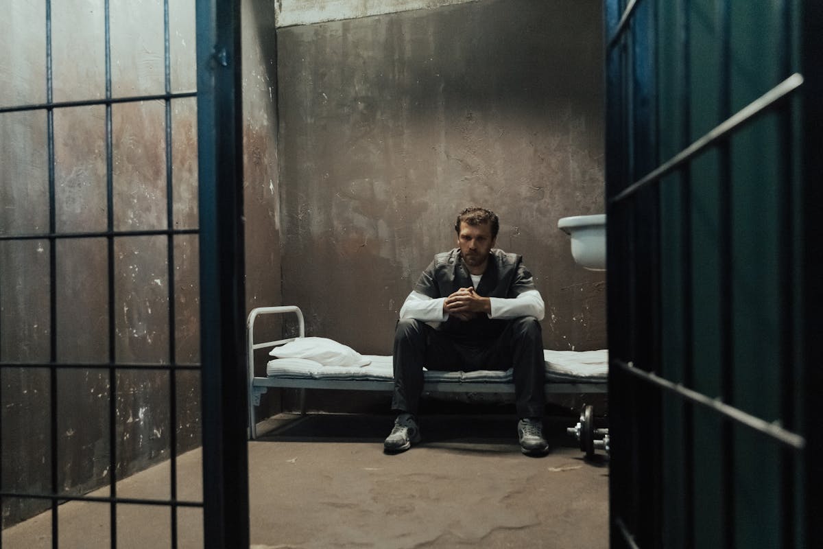 Prisoner Sitting in Cell