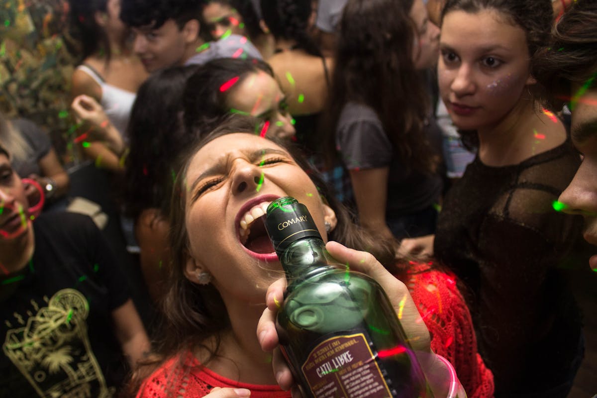 Woman Wearing Red Shirt Drinking