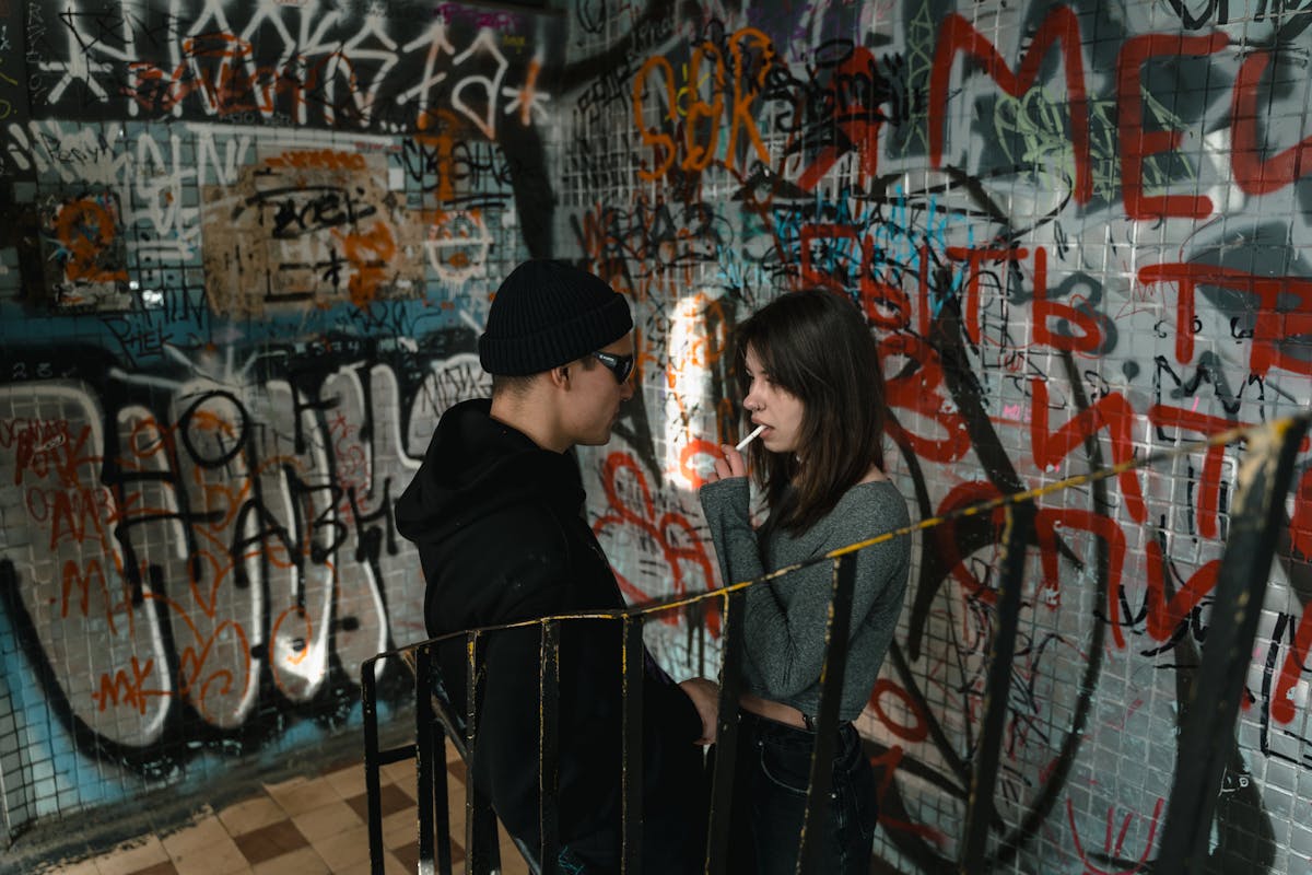 Young adults in a graffiti-covered setting
