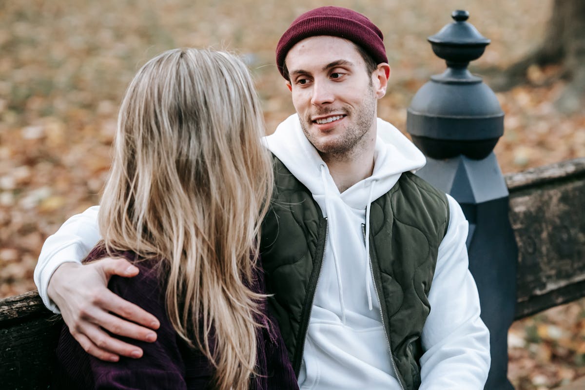Young man smiling and embracing woman